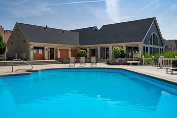 A large swimming pool in front of a building.